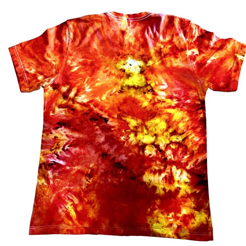 May include: A short-sleeved t-shirt with a vibrant tie-dye pattern in shades of red, orange, and yellow. The shirt's design features a swirling, abstract pattern, creating a unique and eye-catching look. The shirt is made of a soft material.