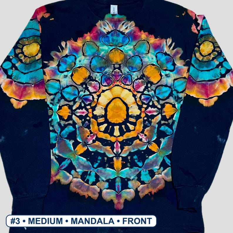 May include: A black long-sleeve shirt featuring a vibrant, symmetrical tie-dye mandala pattern in shades of bright yellow, turquoise, and magenta. The design is centered on the chest and extends onto the sleeves. Text at the bottom reads #3 MEDIUM MANDALA FRONT.