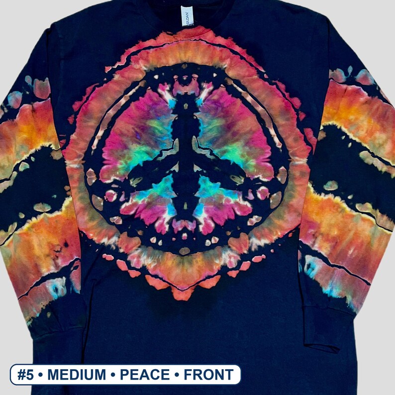 May include: A black long-sleeve shirt featuring a large, central tie-dye peace sign graphic in vibrant shades of pink, orange, and teal. The sleeves also display matching tie-dye patterns. The text #5 &bull; MEDIUM &bull; PEACE &bull; FRONT is visible.