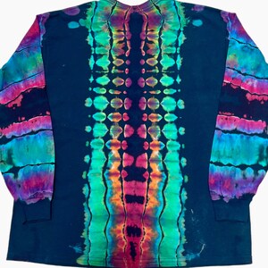 May include: A long-sleeve shirt featuring a dark navy blue base with a vertical tie-dye pattern running down the center. The design includes vibrant streaks of neon green, bright pink, orange, and turquoise, with matching tie-dye sleeves.