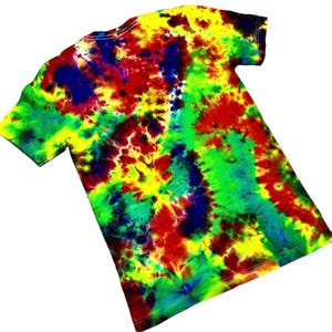 May include: A tie-dye t-shirt with a vibrant mix of colors. The shirt features a swirling pattern of yellow, red, green, and blue hues. The short-sleeved tee is made of a soft material and is suitable for casual wear.