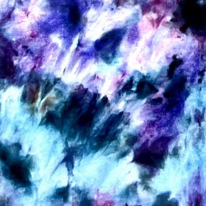 May include: A fabric surface featuring a tie-dye pattern with blended shades of deep purple, royal blue, light cyan, and white. The colors transition in a soft, blurred manner across the material, creating an abstract and mottled appearance.