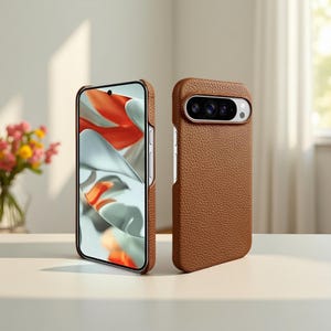 May include: Two brown leather phone cases. One case is displaying a phone screen with an abstract design of orange and white shapes. The other case is standing upright, showcasing the camera module. The cases are on a white surface.