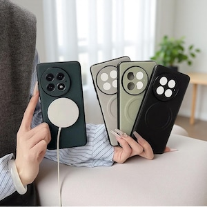 May include: Several mobile phone cases in shades of green, grey, and black. Each case has a circular magnetic attachment and a camera module design. The cases are displayed, highlighting their design and features.