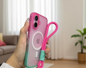 May include: A pink and green phone case with a matching pink lanyard. The case has a clear back with a pink gradient and a white Apple logo. The lanyard is attached to the case with a light blue accent.