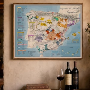 May include: A rectangular wall map titled Regiones vitivinícolas de España, featuring a detailed topographical map of Spain with color-coded wine regions, a legend on the left side, and an inset for the Canary Islands on a light blue background.