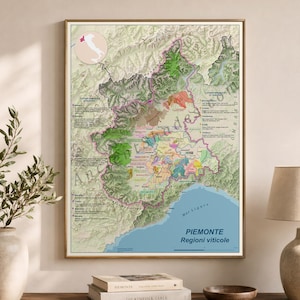 May include: A framed wall map titled Piemonte Regioni viticole, displaying the wine regions of the Piedmont area in Italy. The map features detailed topographical terrain, color-coded viticultural zones, and text labels in Italian.