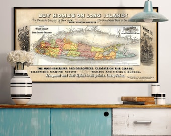 May include: A vintage map of Long Island, framed in black, hangs above a distressed blue and white cabinet. The map features text that reads "BUY HOMES ON LONG ISLAND!" and "Cool in Summer, Warm in Winter." A vase with white flowers and decorative books sit on the cabinet.