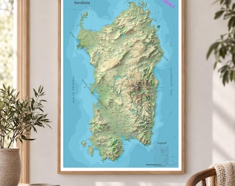 May include: A framed topographic map of Sardinia featuring detailed terrain relief in shades of green and brown against a light blue sea. The map includes the text Sardinia, Version 1, and a legend. The print is displayed in a wooden frame.
