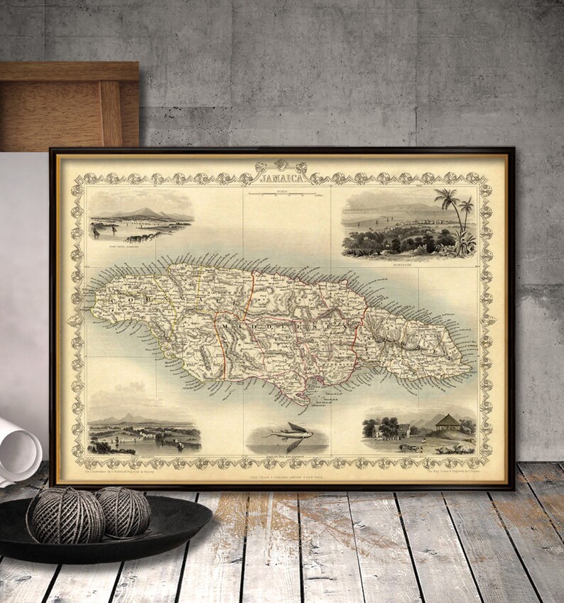 May include: An antique map of Jamaica, printed in black and white with red accents. The map shows the island's coastline, rivers, and major towns. The title "Jamaica" is printed at the top of the map. The map is framed in a black frame.