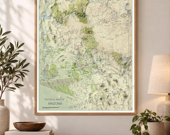 May include: A framed physical map of Arizona featuring topographical relief shading in shades of green and tan. The map displays county names, major cities, and geographical features, with the text Physical Map of Arizona printed at the bottom.