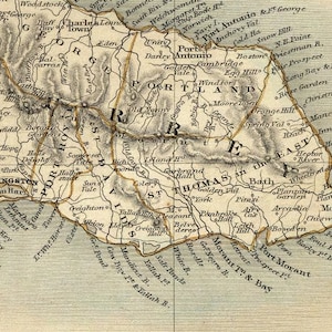 May include: An antique map of Jamaica, showing the island's geography and towns. The map is printed in black and white with brown and yellow accents. The map includes the names of towns, rivers, and other geographical features.