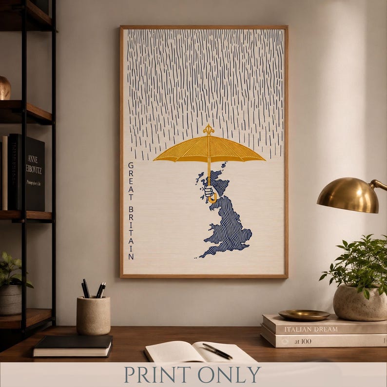 May include: A framed vertical wall art print featuring a stylized map of Great Britain in dark blue with wavy lines. A hand holds a bright yellow umbrella over the map, while dark blue vertical rain lines fall from the top of the print.