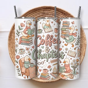 May include: Three white insulated tumblers with black straws, decorated with a charming design of ducks reading books, coffee cups, and the text "Coffee & Chapters." The tumblers feature floral and heart motifs, creating a cosy, book-themed aesthetic.