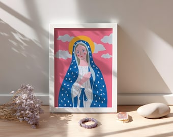 May include: A framed art print featuring a stylized illustration of a woman with a blue veil adorned with white dots. The artwork has a pink background with clouds and a yellow halo. The print is in a white frame.