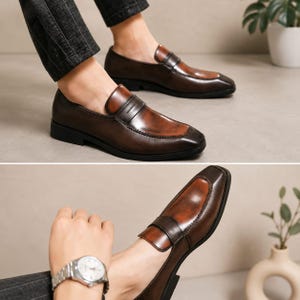 May include: A pair of brown leather penny loafers featuring a polished finish with darker burnished edges, a square toe, a classic saddle strap across the vamp, and a low black heel, shown from both a side profile and an angled perspective.
