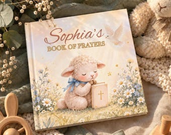 May include: A square hardcover book titled Sophia's BOOK OF PRAYERS. The cover features a light-colored illustration of a fluffy lamb with a blue bow holding a small book with a cross, surrounded by white daisies and a flying dove.