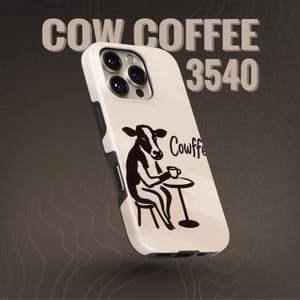 May include: A cream-coloured phone case with a black and white illustration of a cow enjoying coffee. The case has the words "Cow Coffee 3540" printed on it. The case has black accents.