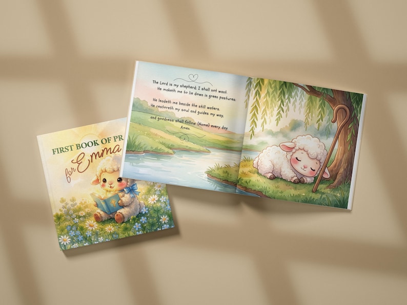 May include: A children's book titled First Book of Prayers for Emma featuring a cover illustration of a lamb reading a book in a field of flowers and an open page showing a sleeping lamb under a tree with the text The Lord is my shepherd.