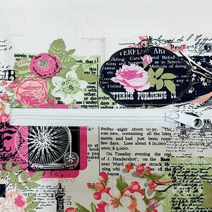 May include: A white fabric bag with a zipper closure. The bag is decorated with a floral pattern and text, including the words "JOUR", "TERFE ART", "ATTERICK PUBLISHING CO", and "PARIS".