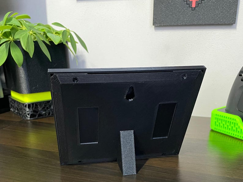 Rear of the plaque upright on its removable black desk stand.