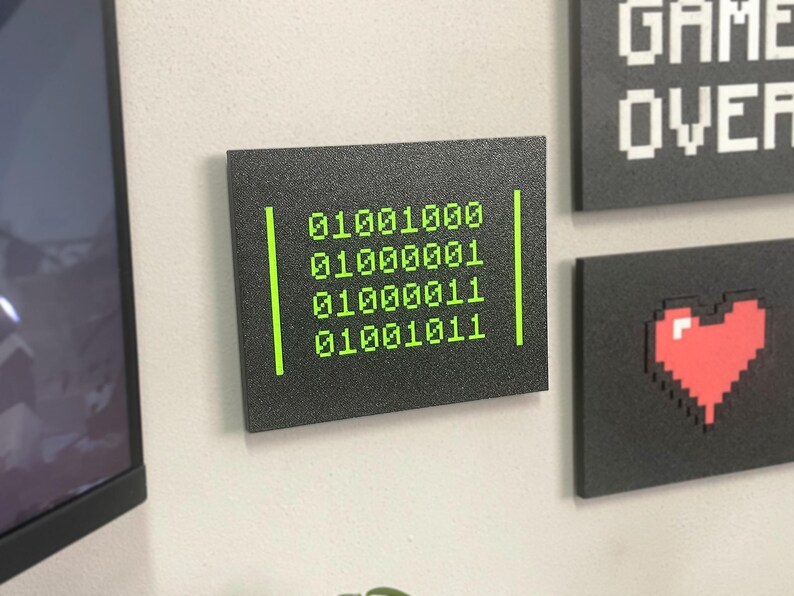 Close wall view of the HACK Binary plaque with other designs sold separately.