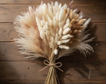 May include: A dried floral bouquet featuring pampas grass, bunny tails, and other dried flowers in shades of cream, tan, and light brown. The stems are tied together with twine, creating a rustic and natural aesthetic. The bouquet rests on a wooden surface.