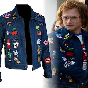 May include: A dark blue denim jacket adorned with colorful patches, including a musical note, a cherry, a cactus, and a rocket. The jacket has a classic collar and a zipper closure. The patches add a unique, artistic flair to the garment.