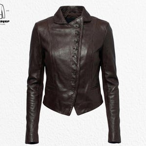 May include: A dark brown leather jacket with a button-up front and a collared neckline. The jacket has long sleeves and a tailored fit. The North Layer Jackets Store logo is in the upper left corner.