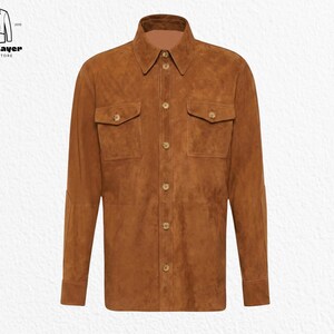 May include: A brown suede shirt with two chest pockets and button fastenings. The long-sleeved shirt has a classic collar and is from the North Layer Jackets Store.