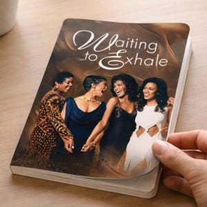 May include: A book with the title "Waiting to Exhale" features a cover image of four women in elegant attire. The women are smiling and holding hands. The book is being held open, revealing the pages within.