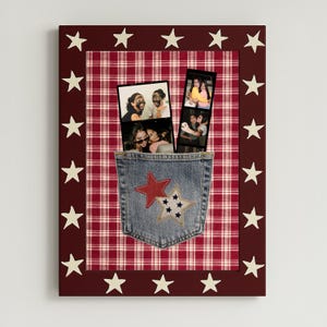 May include: A patriotic-themed photo frame with a red and white plaid background and a denim pocket. The frame is bordered with a dark red color and white stars. Two photo strips are inserted into the denim pocket.