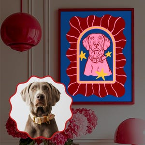 May include: A framed art print featuring a pink dog portrait with yellow stars on a blue background, set within a red wavy frame. A real dog portrait is in a round frame in the foreground. The image is a dog-themed art piece.