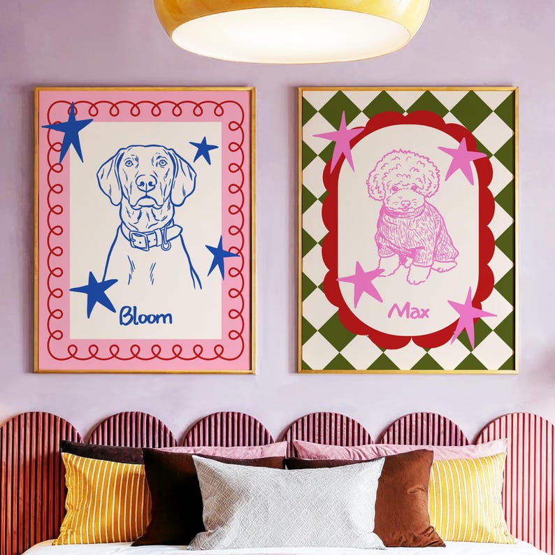 May include: Two framed dog portraits. One features a blue line drawing of a dog named Bloom, surrounded by blue stars and a pink border. The other shows a pink poodle named Max, set against a green and white checkered background with pink stars.