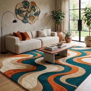 May include: A modern living room featuring a cream sofa, wooden coffee table, and a large rug with a wavy design in teal, orange, and beige. The room is decorated with a wall hanging and potted plants, creating a stylish space.