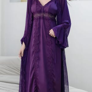 May include: A deep purple satin nightgown and matching sheer robe set. The nightgown features a V-neck with lace detailing and a flowing skirt. The robe has bell sleeves and intricate lace trim. A luxurious and elegant sleepwear ensemble.