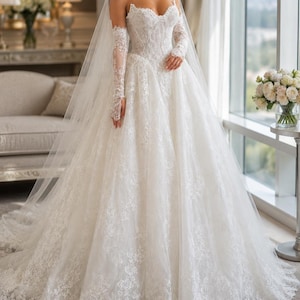 May include: A white strapless ball gown wedding dress featuring a sweetheart neckline, intricate lace embroidery throughout the bodice and full skirt, and matching sheer lace gloves that extend to the mid-forearm, paired with a long, flowing veil.