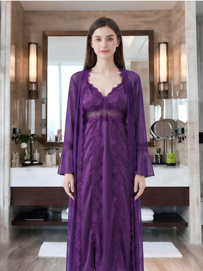 May include: A purple lingerie set featuring a long, sheer robe with bell sleeves and a matching slip dress. The dress and robe are adorned with intricate lace detailing. The set is designed for sleepwear and loungewear.