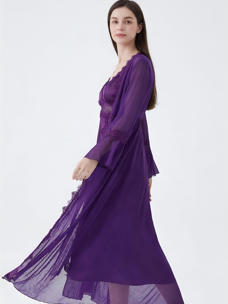 May include: A flowing, deep purple lingerie set. The set includes a long, sheer robe with lace trim and a matching slip. The fabric appears lightweight and the design is elegant. The robe has long sleeves and a V-neckline.