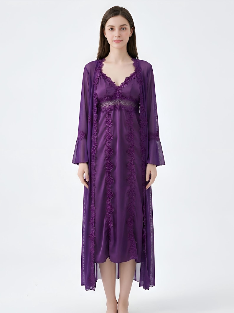 May include: A purple lingerie set featuring a satin slip dress with lace detailing and a matching sheer robe. The robe has bell sleeves and lace trim. The set is designed for comfort and elegance.