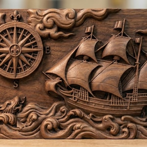 May include: A carved wooden nautical scene featuring a compass, a sailing ship, and ocean waves. The artwork is in shades of brown and depicts a detailed relief carving of a ship at sea, with a compass rose and stylized waves.