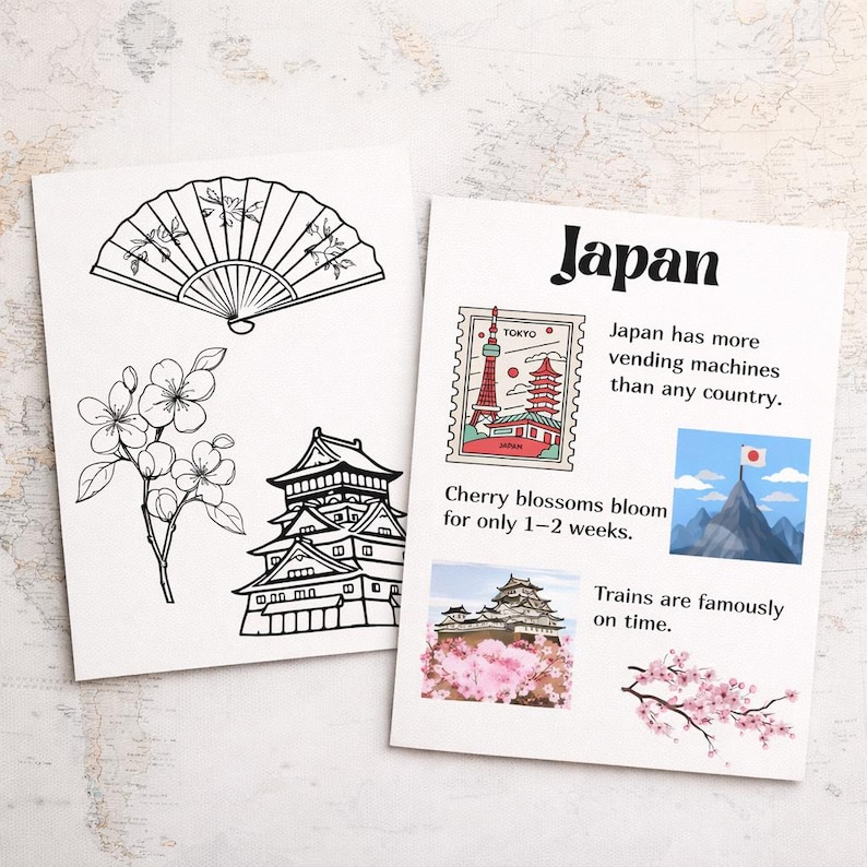 May include: Two white cards with Japanese-themed illustrations. One card features a fan, cherry blossoms, and a castle. The other card says "Japan" and includes facts about Japan, a stamp with the Tokyo Tower, and a mountain with a flag.