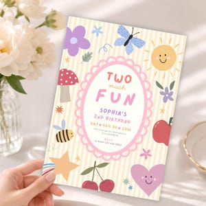 May include: A rectangular birthday invitation card with a light yellow and white striped background. The center features a pink scalloped oval frame containing the text TWO MUCH FUN, SOPHIA'S 2ND BIRTHDAY, SAT SEP 26 2PM, and RSVP details.