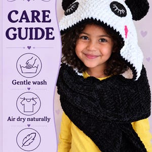 Puede incluir: Una capucha de panda tejida a ganchillo en blanco y negro con bufanda integrada, con ojos cerrados bordados y orejas redondas. La imagen incluye el texto: CARE GUIDE, Gentle wash, Air dry naturally y Helps keep the softness longer.
