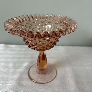 May include: A rustic wooden sign with the text "Welcome to our home" in white lettering. The sign features a distressed finish and a simple, inviting design, perfect for a front porch or entryway.