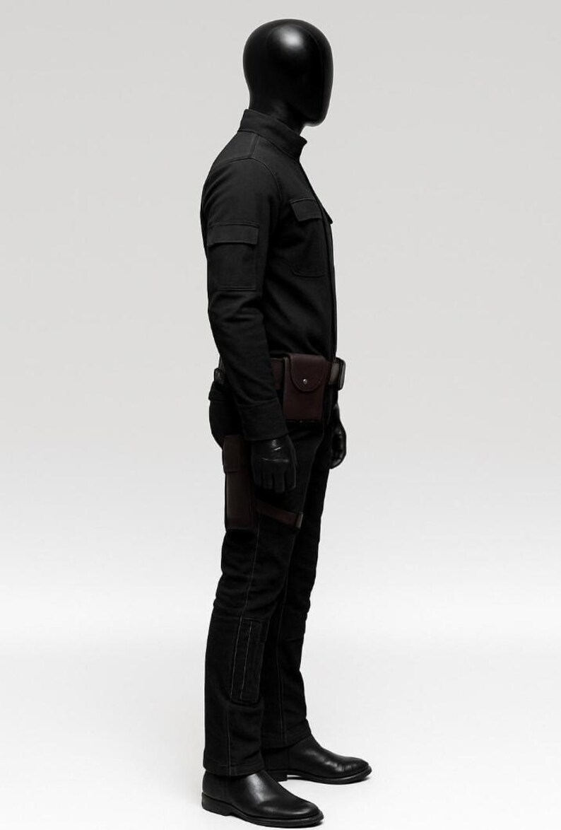 May include: A black outfit consisting of a long-sleeved shirt, pants, gloves, and boots. The outfit includes a brown leather belt with pouches and a holster. The mannequin is wearing a black helmet.