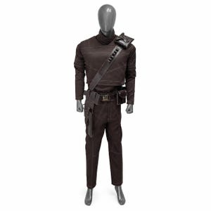 May include: Brown costume with a high collar, long sleeves, and matching pants. The outfit includes a shoulder bag, belt with pouches, and a strap across the chest. White stitching accents the seams. The costume is displayed on a mannequin.