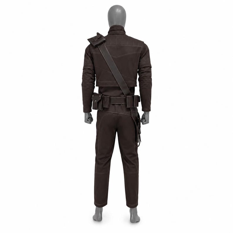 May include: A brown costume displayed on a mannequin. The outfit includes a jacket with shoulder accents, a belt with pouches, and matching pants. A strap crosses the chest. The costume is designed with visible stitching.