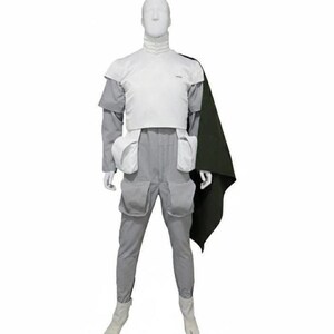 May include: A white and light grey jumpsuit featuring a high collar, short sleeves, and a white chest plate. The garment includes four large utility pockets on the hips and thighs, paired with a dark olive green cape draped over the left shoulder.