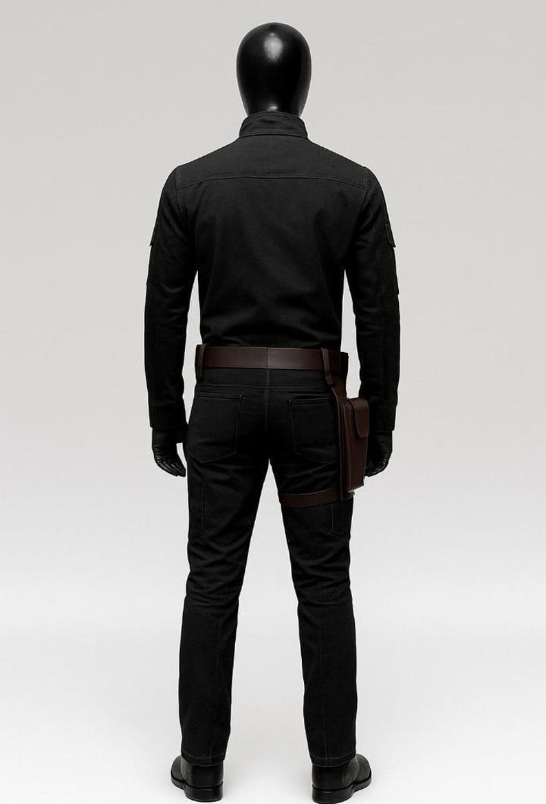 May include: A black outfit consisting of a long-sleeved shirt, pants, and boots. The outfit includes a brown leather belt, a holster, and gloves. The mannequin is wearing a black helmet.